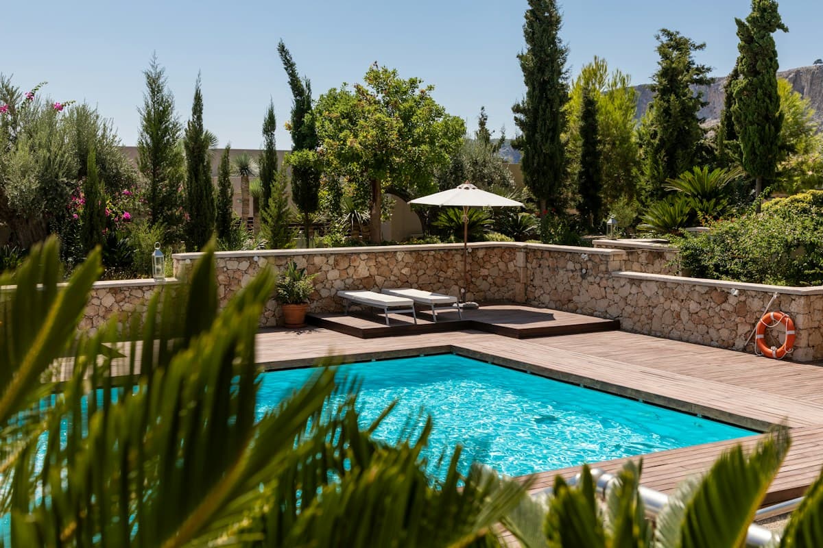 A quiet pool terrace surrounded by greenery